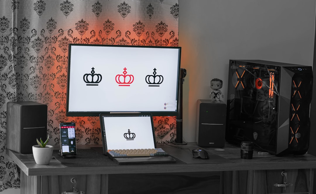 black-flat-screen-tv-turned-on-near-black-speaker-bxzaxfzkz7c